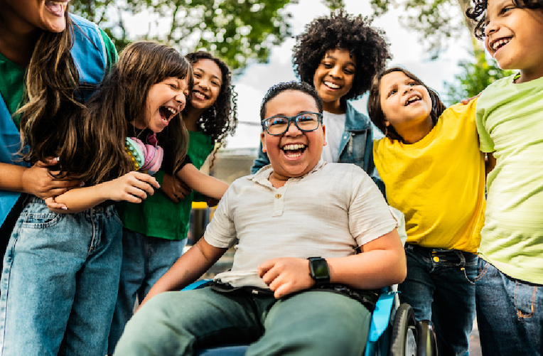 A group of children and adults laughing together